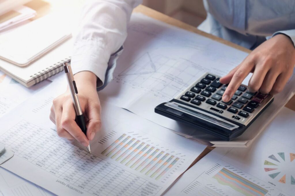 finance accounting concept business woman working desk using calculator